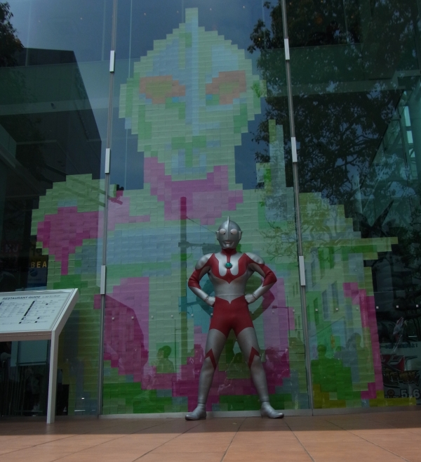 ポスト・イットで作った巨大アート完成に、ご満悦のウルトラマン